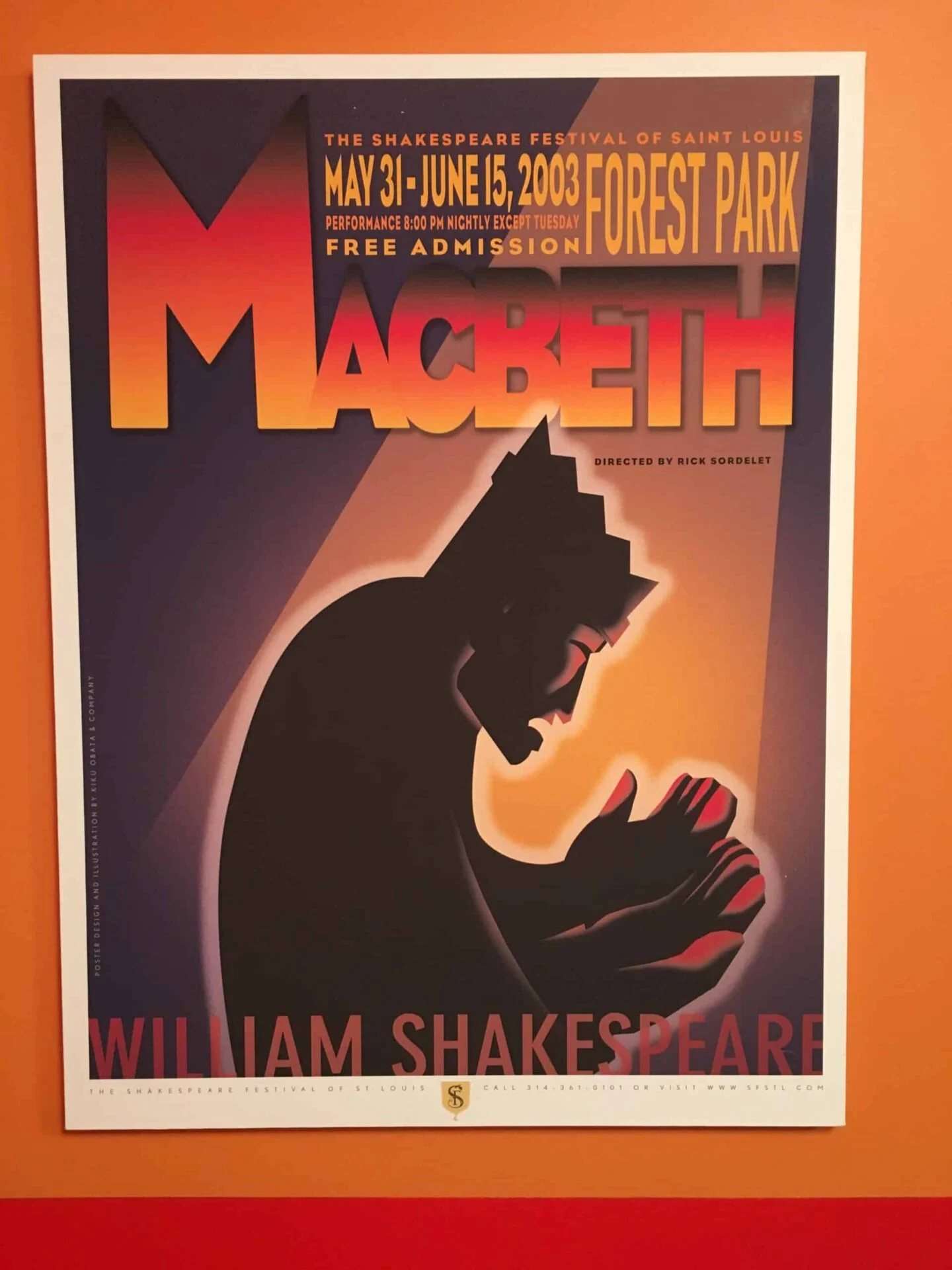 A promotional poster for the "Shakespeare In The Streets" festival featuring "Macbeth" with a silhouette of Macbeth clutching a crown, set against an orange and purple background, displayed with event