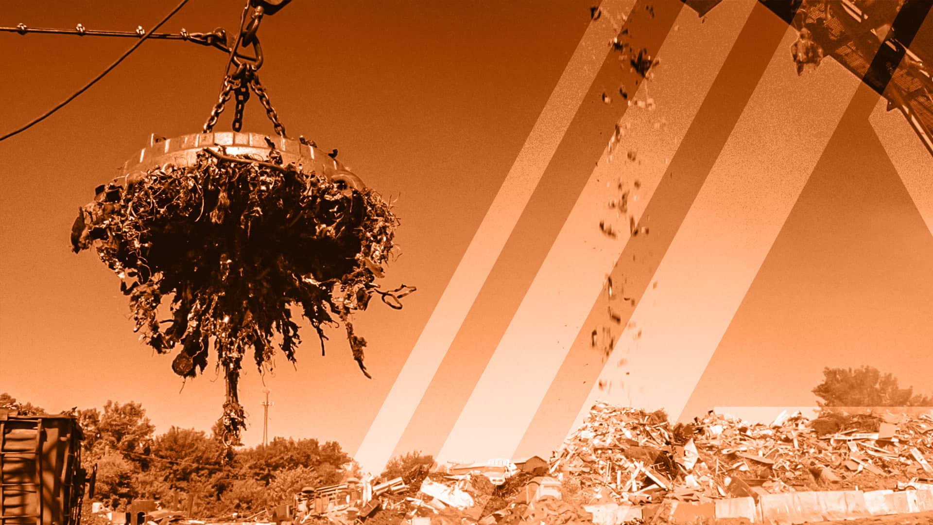 A crane lifting a large pile of scrap metal at a recycling plant, with a distinctive orange filter over the image.