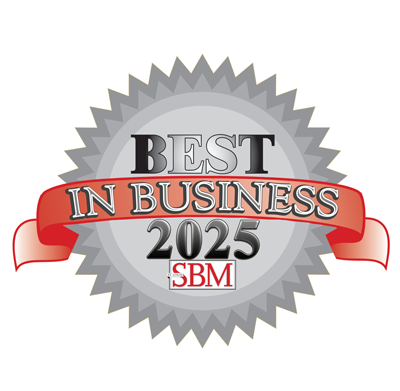 Silver badge with a scalloped edge, displaying "Best in Business 2025" in bold lettering. A red ribbon decorates the badge, and the letters "SBM" are at the bottom.