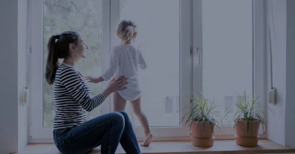 Chaney Windows and Doors case study: a parent and child by a sunny window