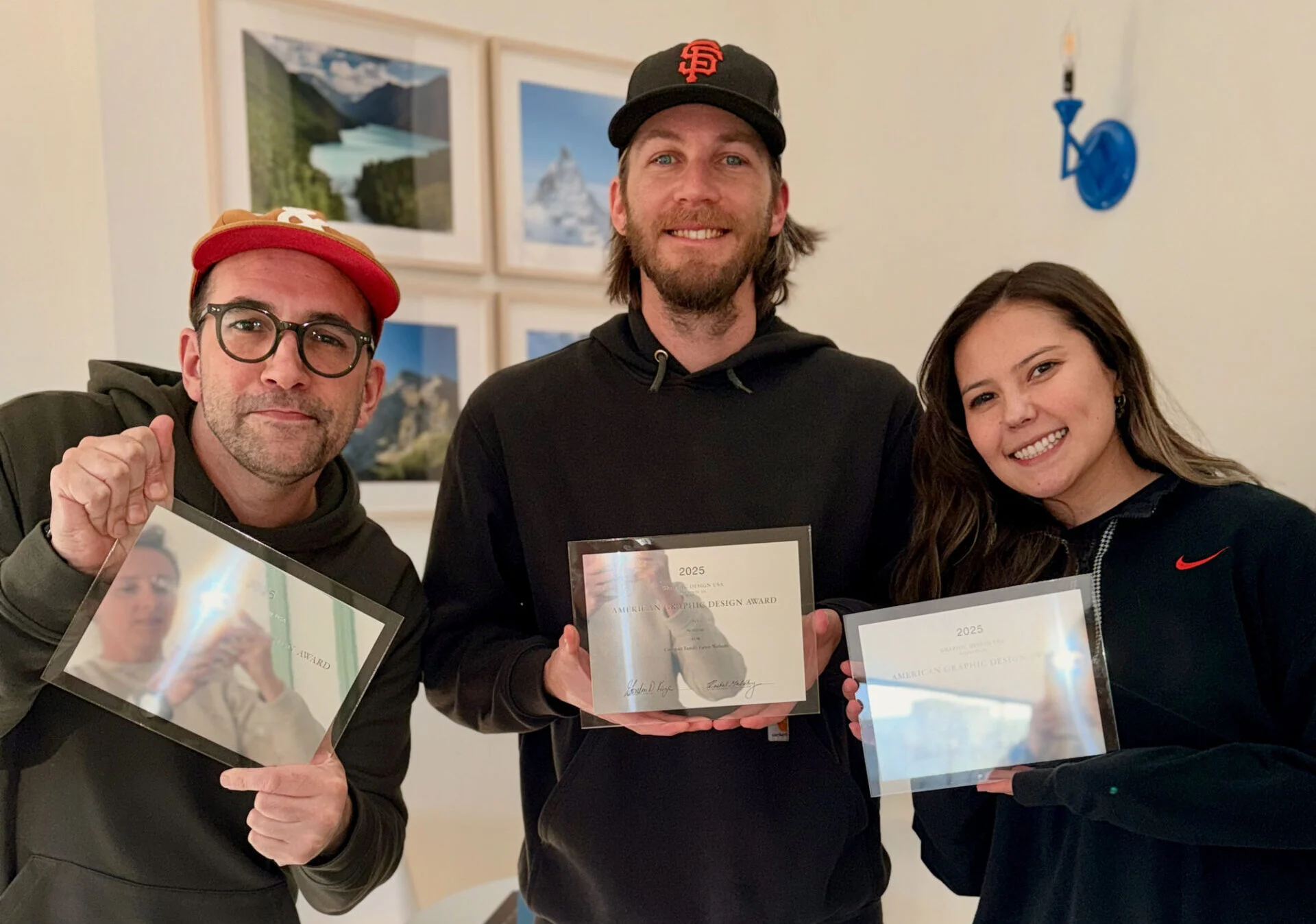 Seafoam team members holding award plaques