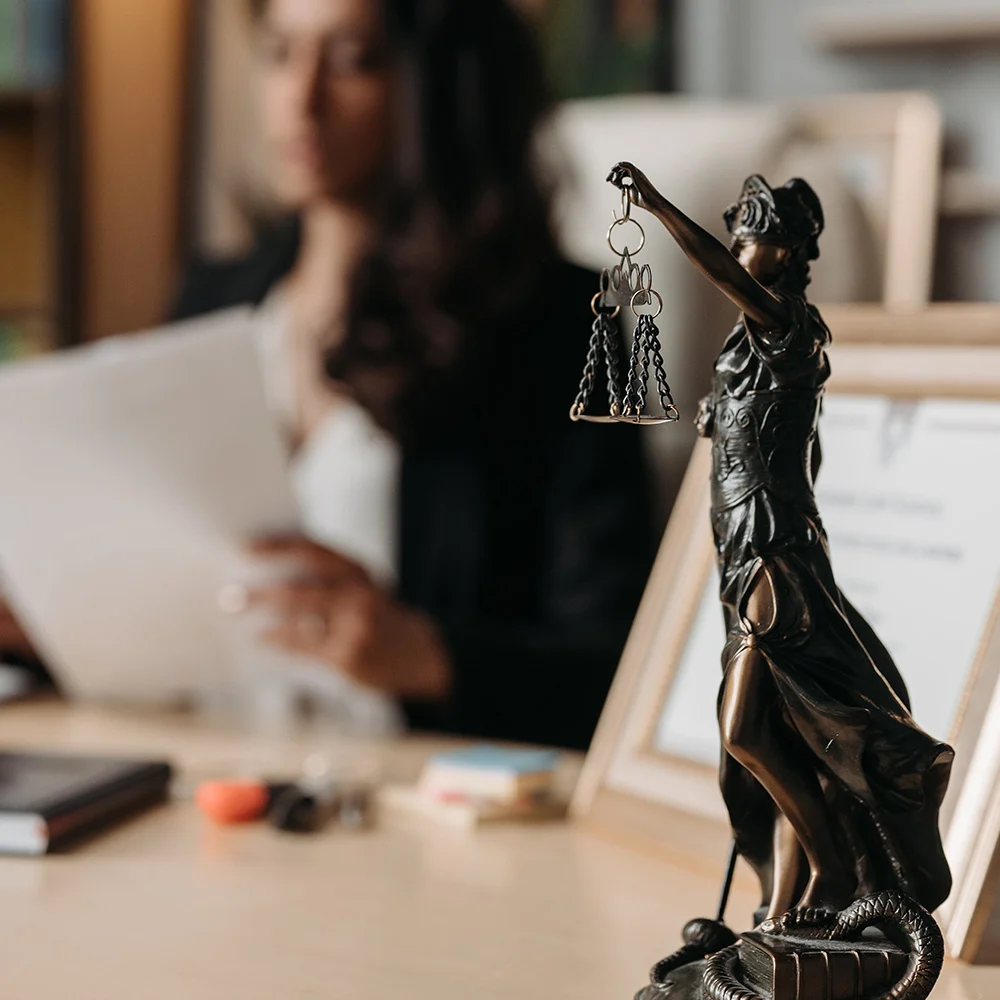 Scales of justice statue on an attorney's desk