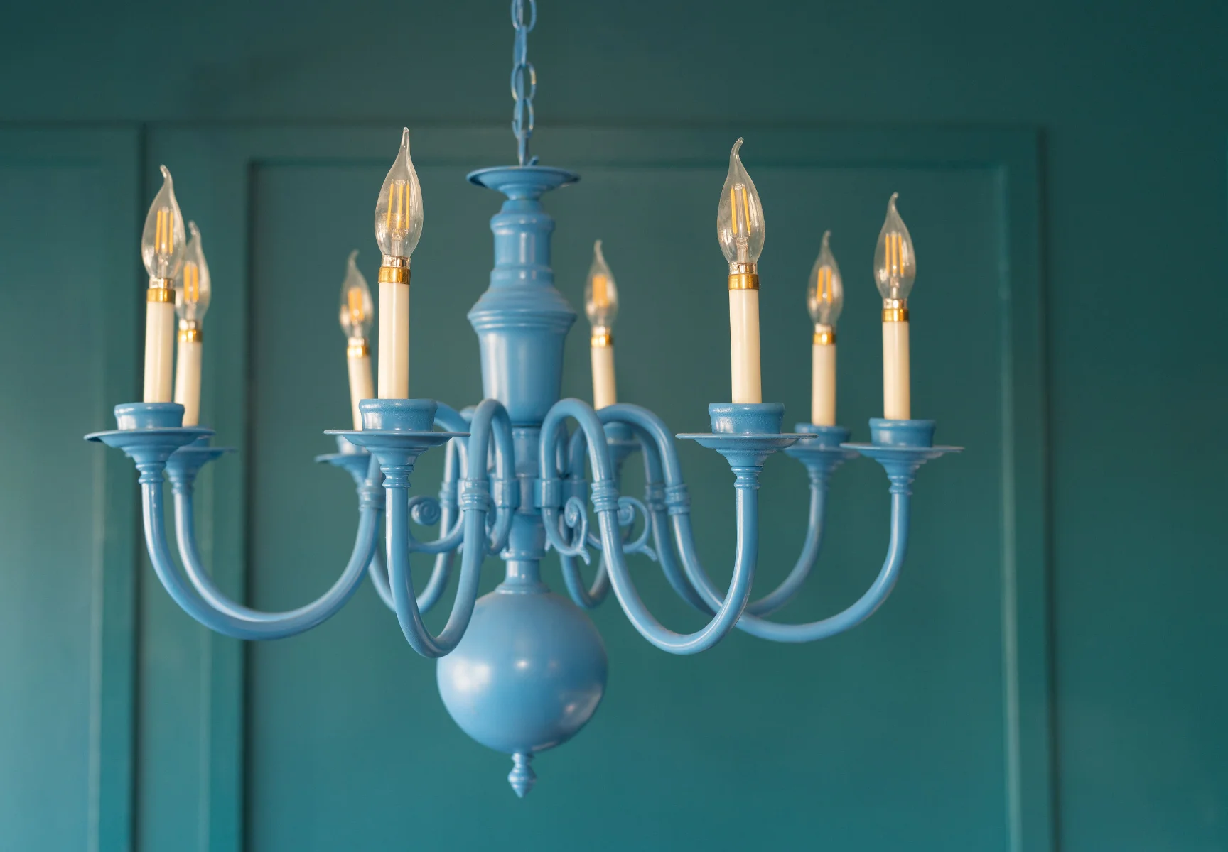 Blue chandelier on the teal wall of the Seafoam office
