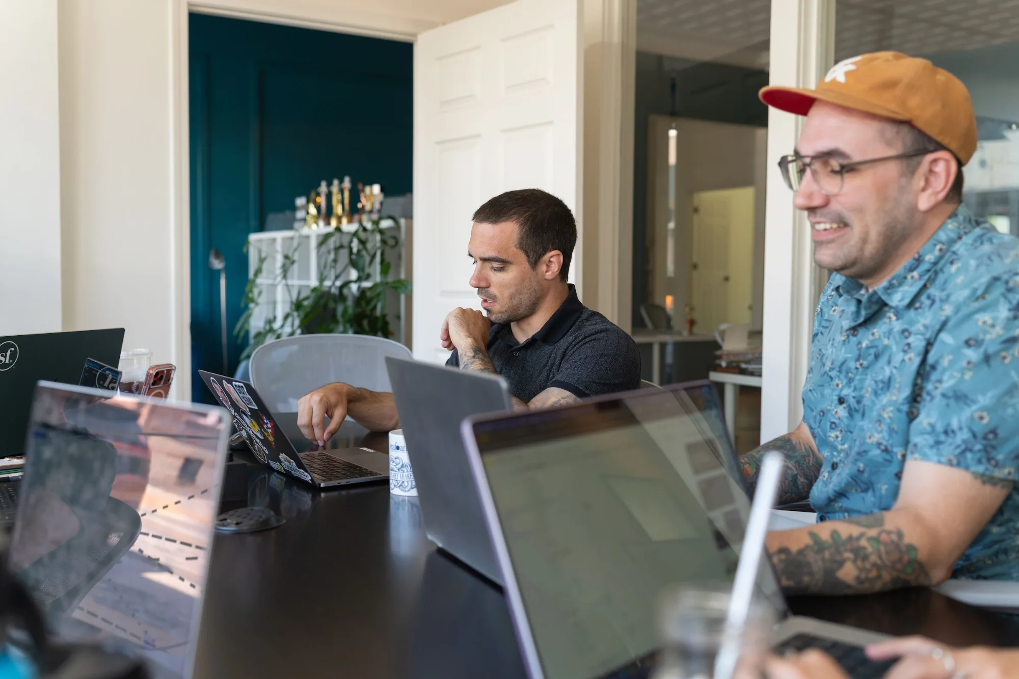 Two Seafoam team members working at laptops in the Seafoam office